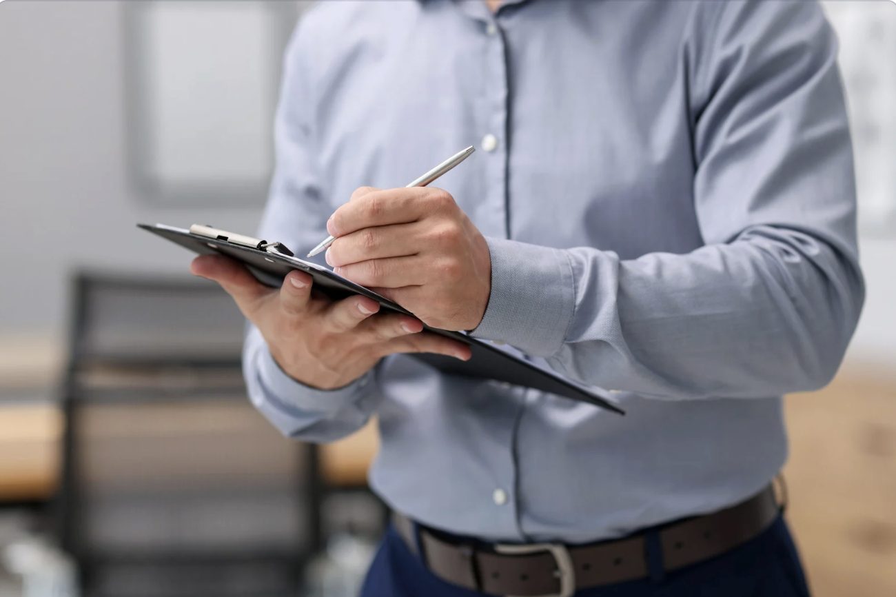 Man writing on a clipboard
